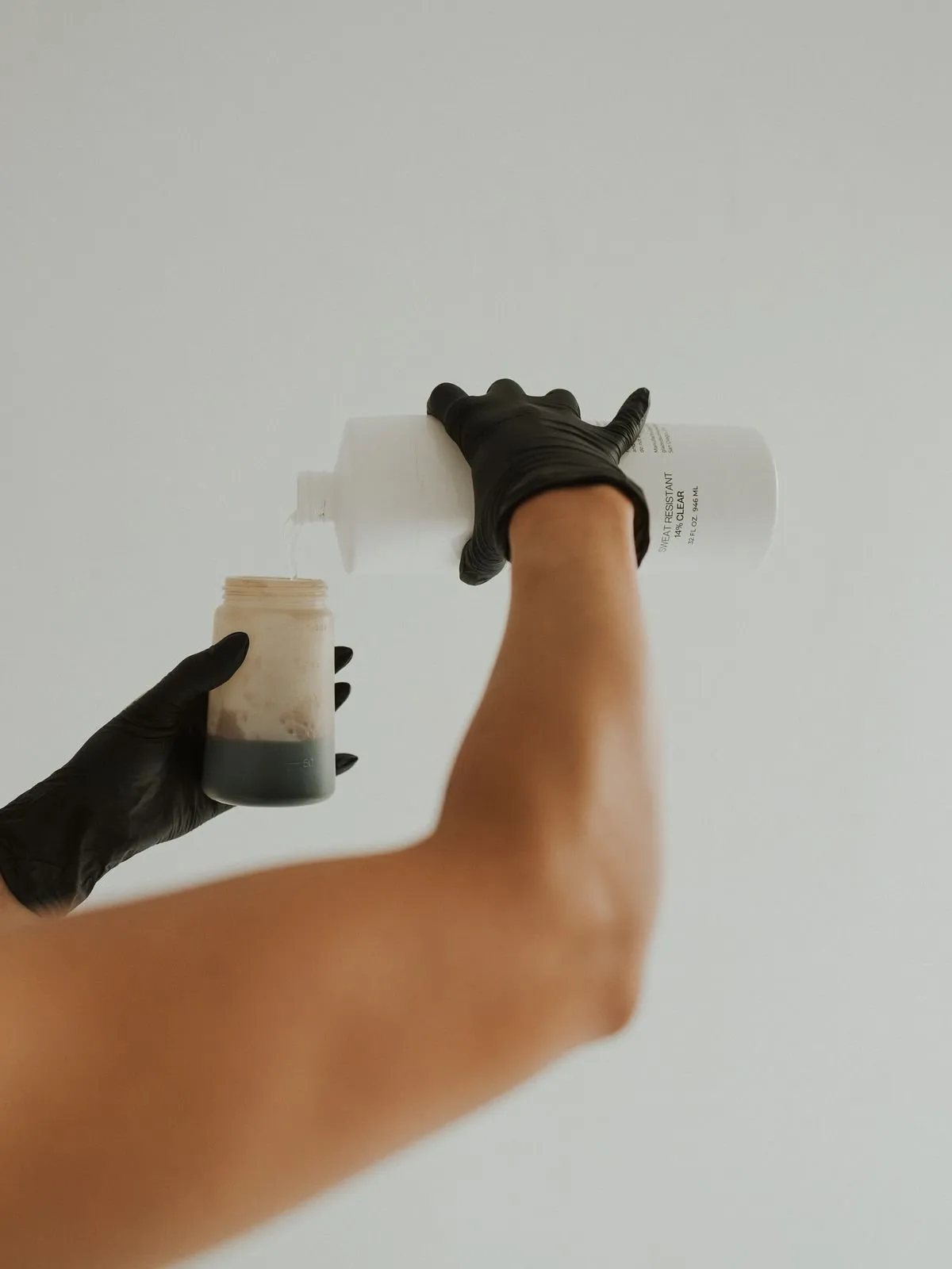 A tan artist preparing a custom airbrush solution